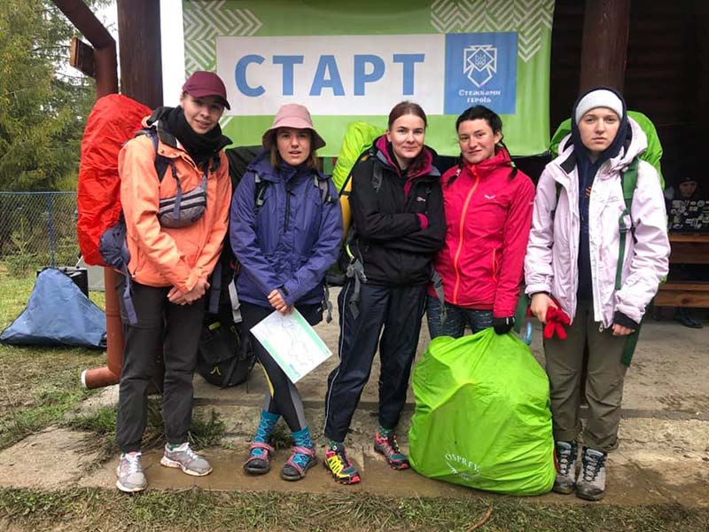 A groupf of young women with camping gear at the start line