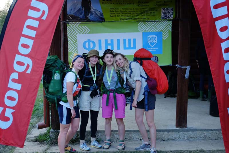 A groupf of young women with camping gear at the finish line