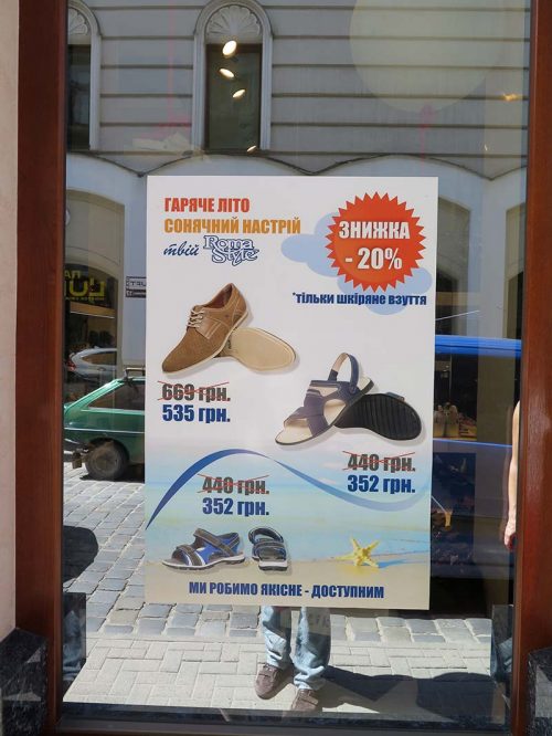 A shoes sales poster on a shop window