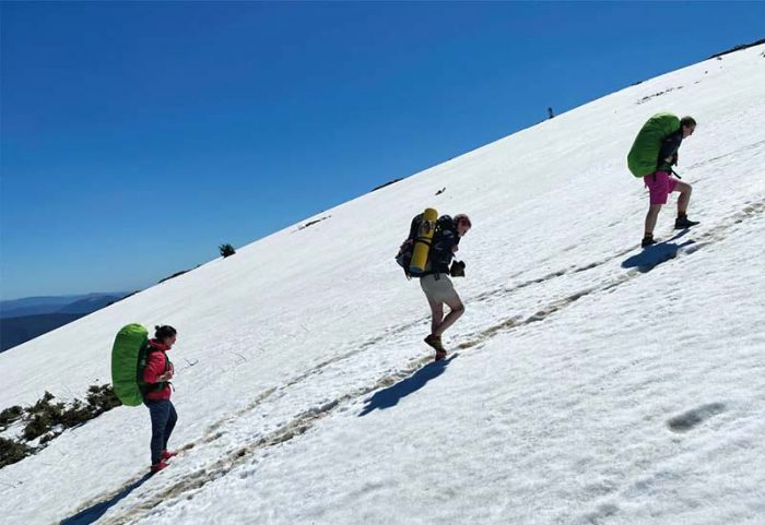 Mountain climbers scending a snow-covered mountain